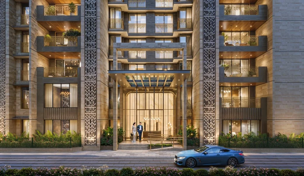 Grand entrance framed by illuminated residences and landscaped gardens